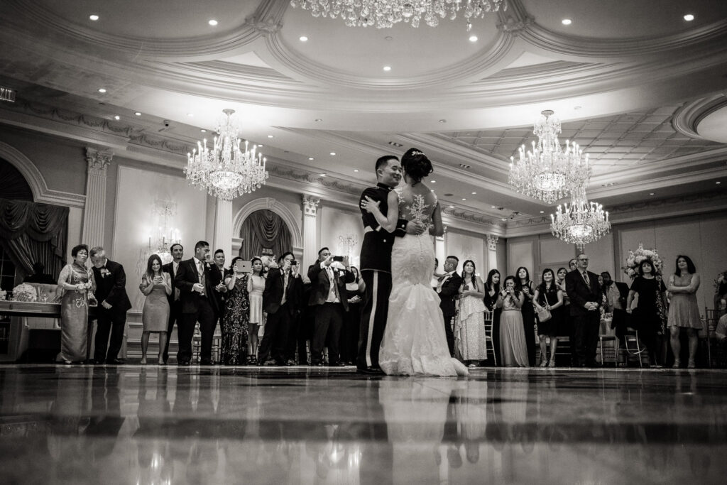 Couple's first dance in elegant ballroom with crystal chandeliers at Rockleigh Country Club