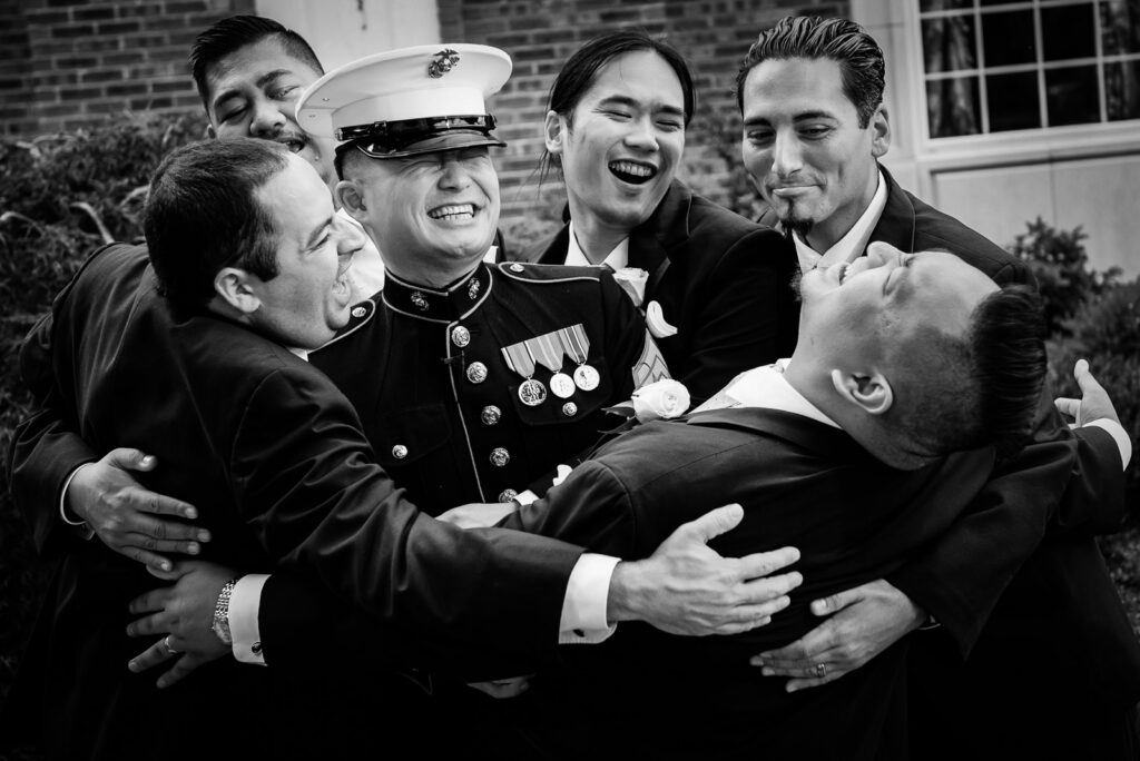 Marine groom in dress blues laughing with groomsmen at Rockleigh Country Club wedding
