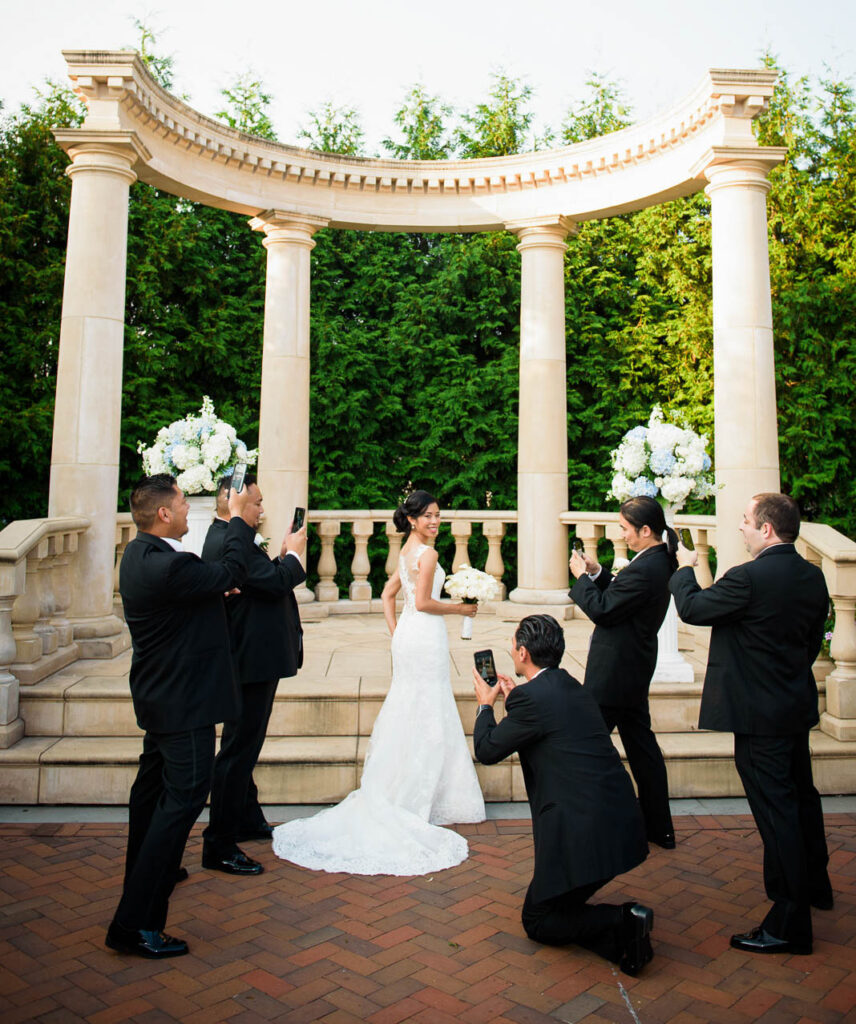 Bride escorted by both parents down aisle at Rockleigh Country Club outdoor ceremony