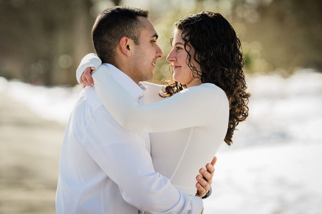 Close-up engagement portrait in winter sunlight at Skylands Botanical Garden, Ringwood NJ