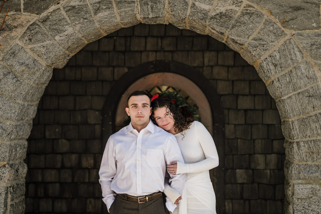 Couple portrait under the historic stone arch at Skylands Botanical Garden, Ringwood NJ