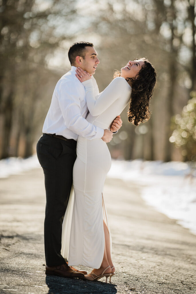 Couple laughing together during a winter engagement session at Skylands, Ringwood, New Jersey