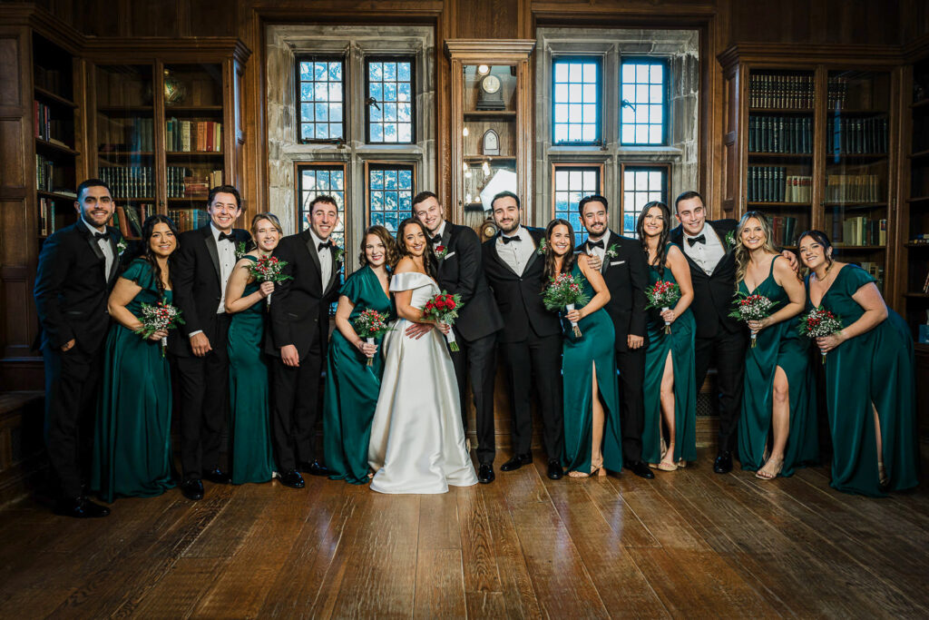 Bridesmaids in emerald dresses laughing at Skylands Manor