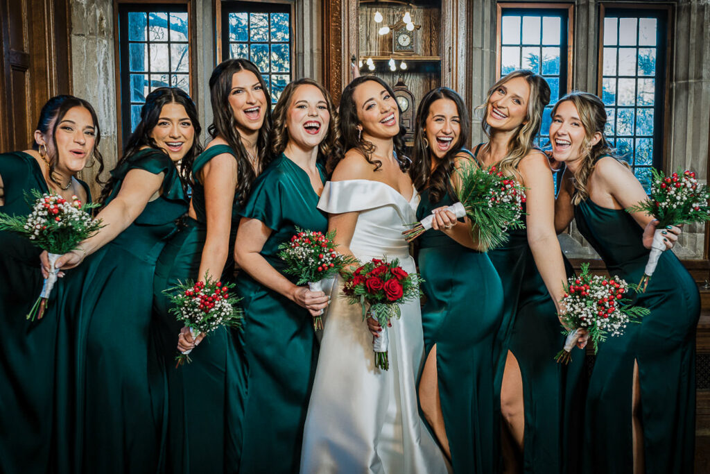 Full bridal party in emerald green and black at Skylands Manor