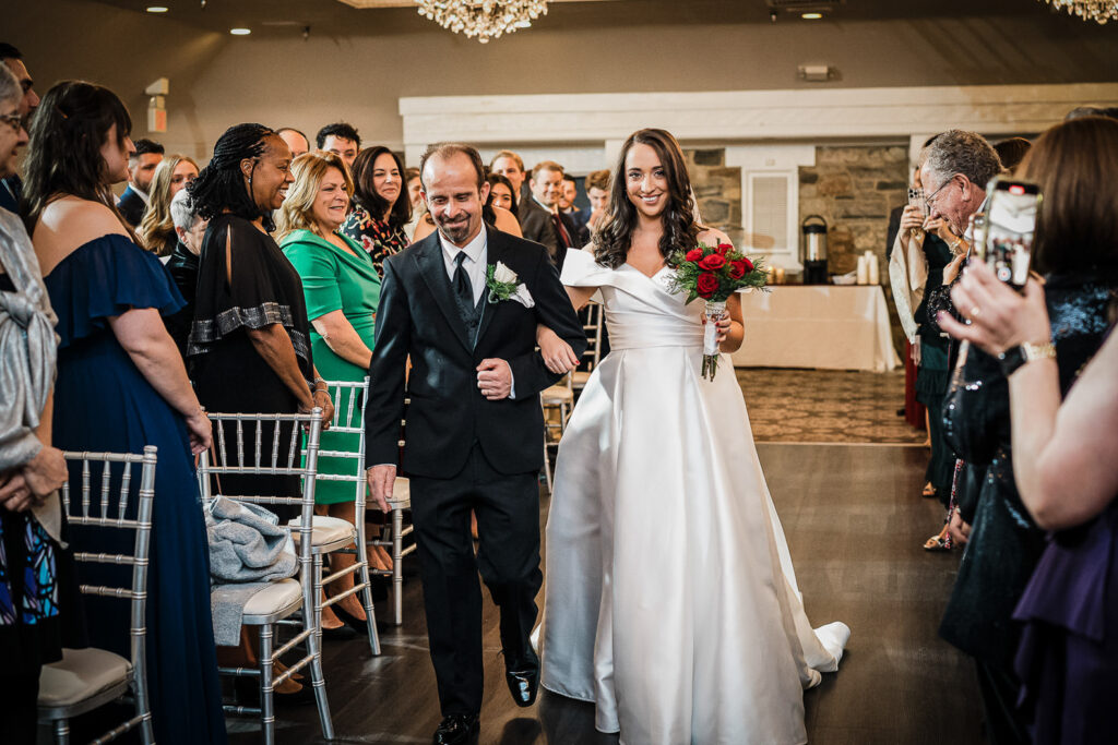 Bride walking down aisle with father at Skylands Manor ceremony