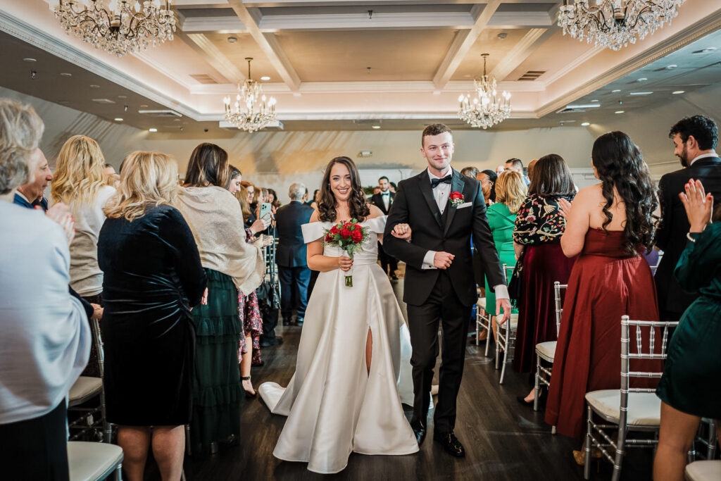 Newlyweds walking down aisle as married couple at Skylands Manor