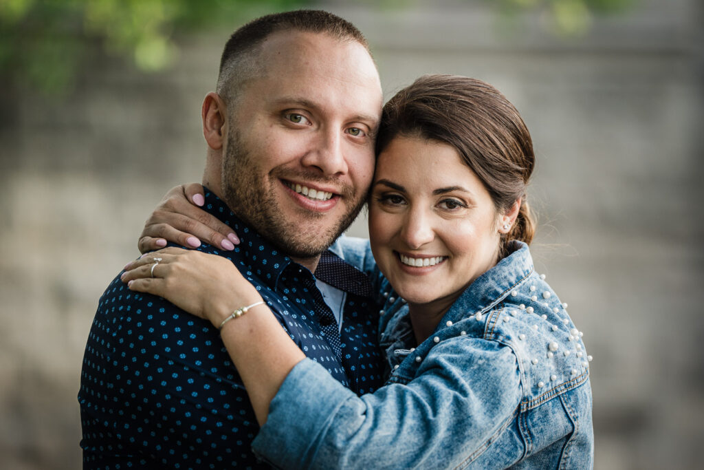 Close up engagement portrait at Verona Park lake with natural lighting and authentic emotion