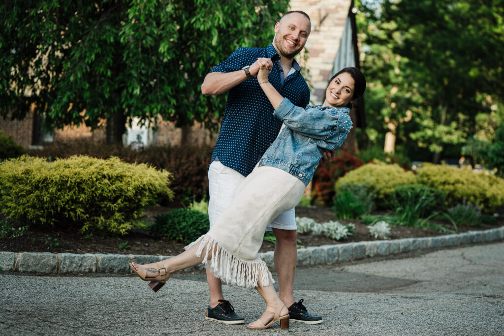 Couple laughing and playing during Verona Park engagement session with landscaped gardens in Essex County NJ