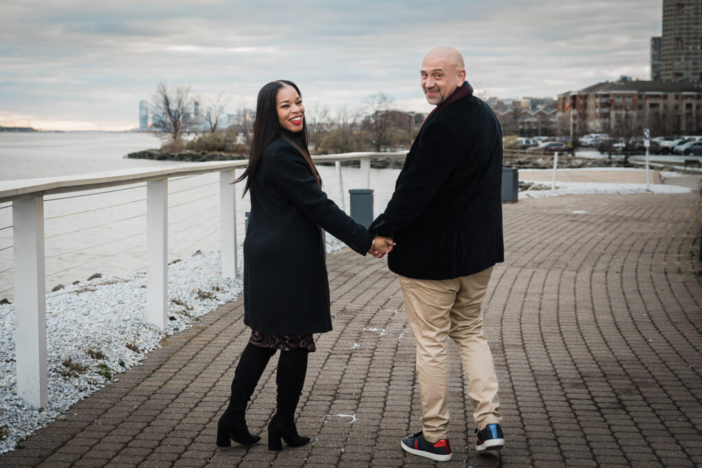 Engagement photo with New York City skyline background at Waterside Restaurant North Bergen winter