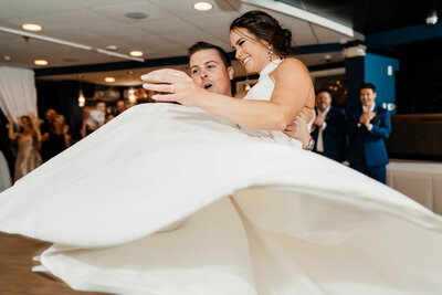 Bride twirling during the first dance at a New Jersey wedding reception with crisp motion in low light