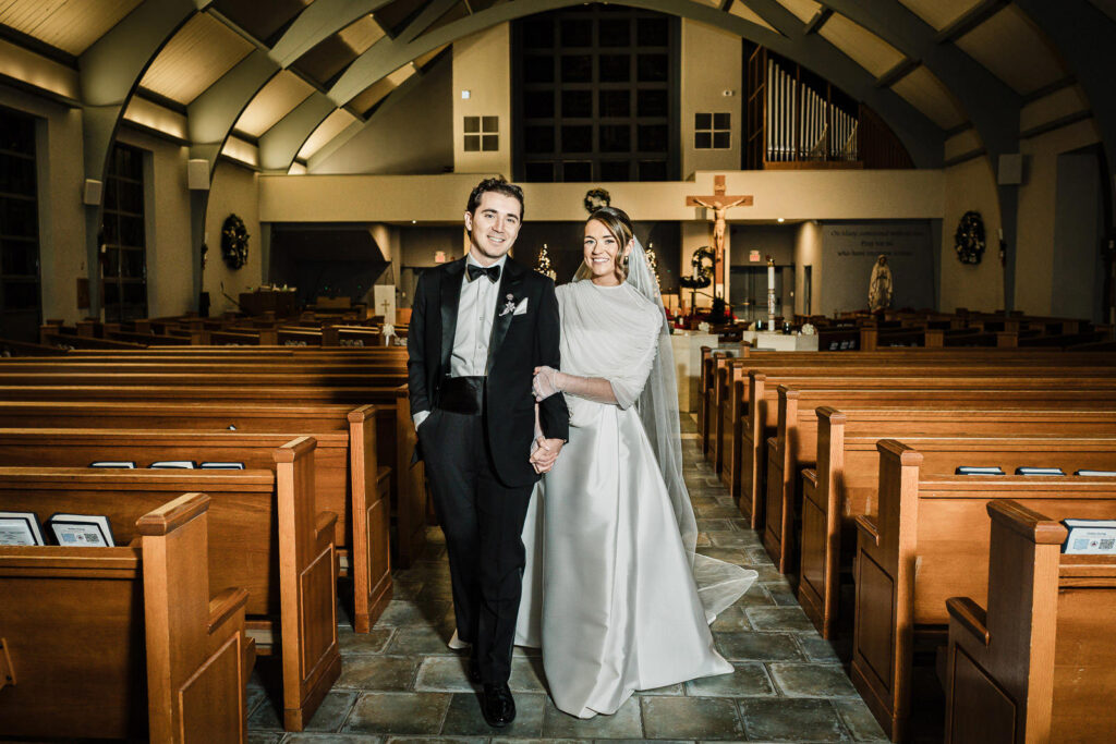 Wide angle portrait of bride and groom inside St. Catharine Church in Glen Rock NJ