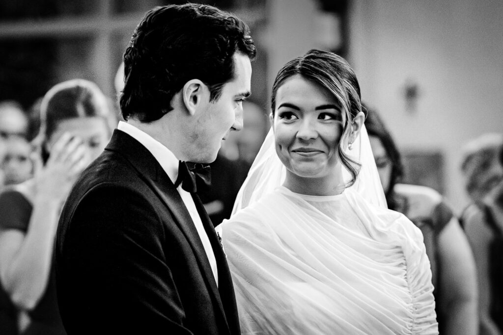 Bride looking at groom with joy during their church wedding ceremony in Glen Rock NJ