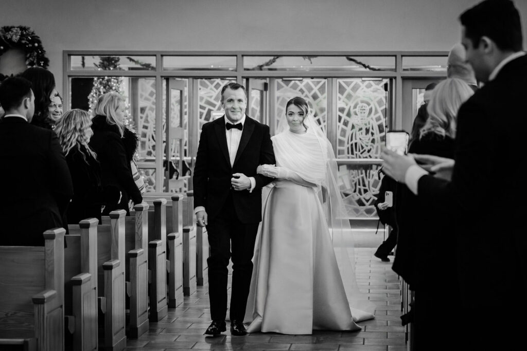 Father walking bride down the aisle during Catholic wedding ceremony at St. Catharine Church in Glen Rock NJ