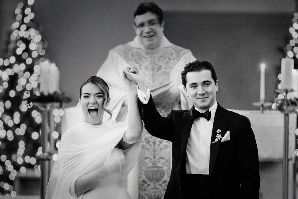 Newlyweds walking down aisle together after their church wedding ceremony in Glen Rock NJ