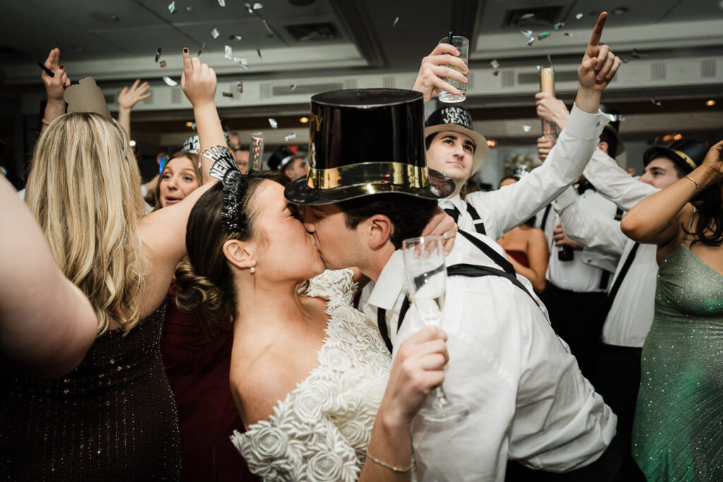 Couple kissing during celebration at their Westin Governor Morris wedding reception in Morristown NJ