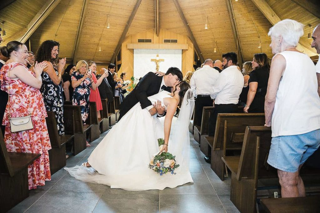 Bride and groom sharing a kiss after their New Jersey church ceremony