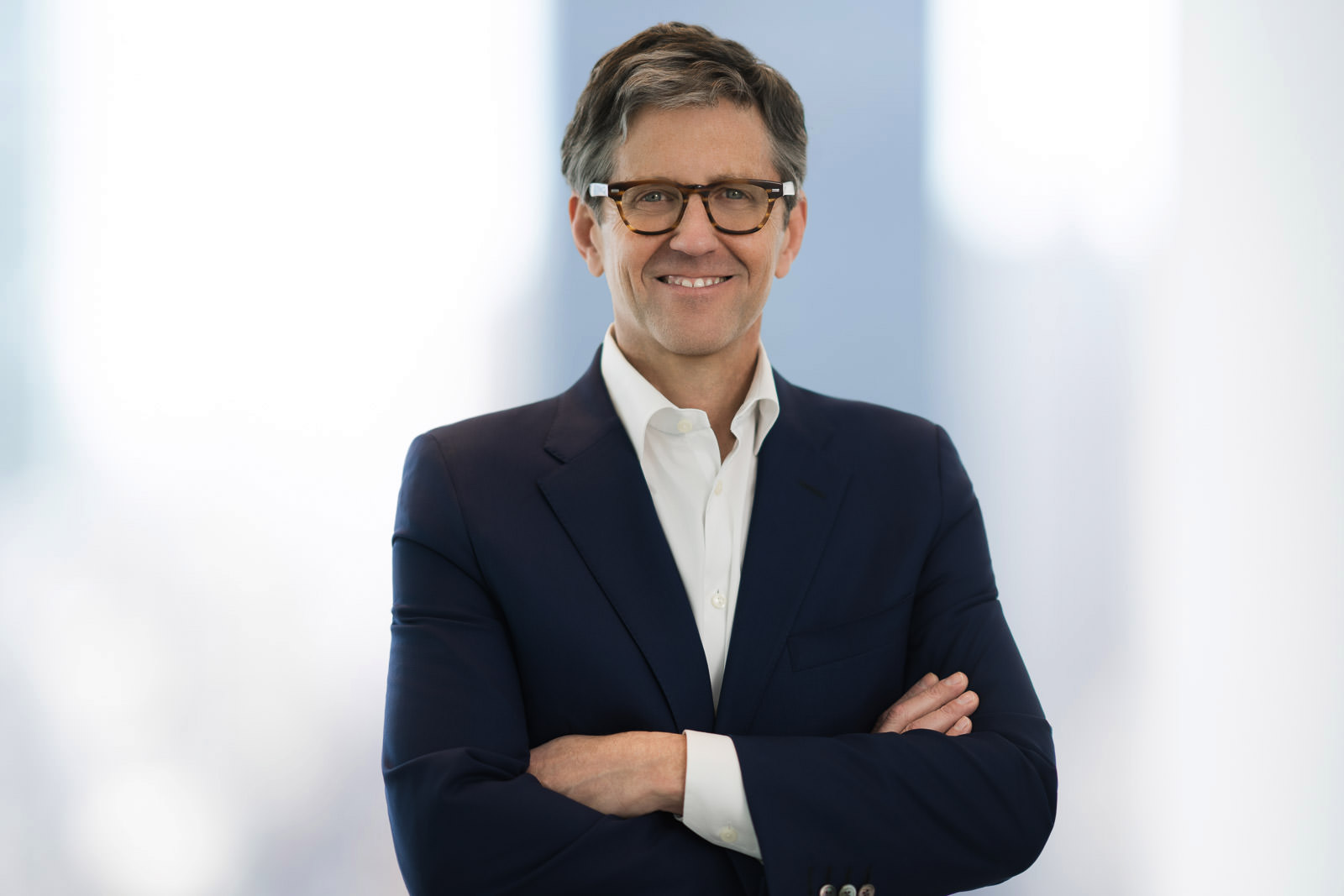 Headshot photographer NJ NYC — confident executive portrait with natural retouching and minimal editing