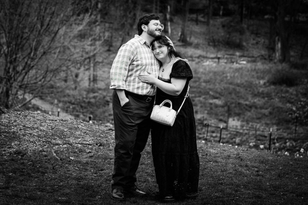 Black and white photo of couple in tender embrace at Reeves-Reed Arboretum in New Jersey spring