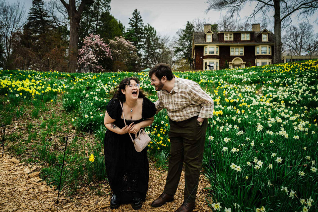 Woman laughing with pure joy after proposal at Reeves-Reed Arboretum daffodil garden New Jersey