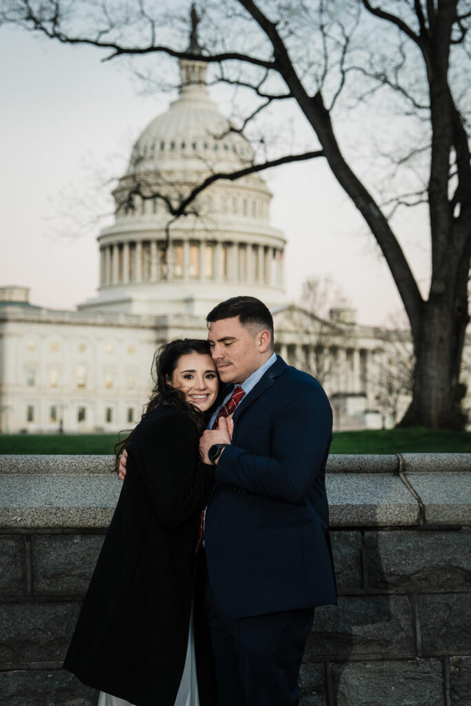 Woman leaning into her smiling partner with the US Capitol dome visible behind them Washington DC