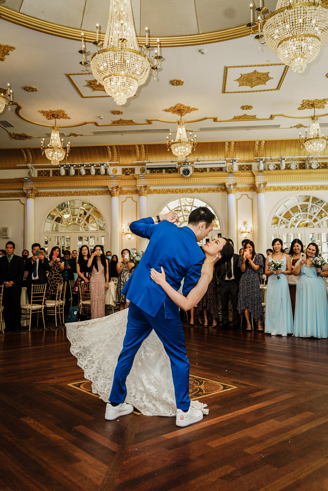 Bride and groom sharing a romantic dip during their first dance under the Crystal Plaza chandeliers in Livingston NJ