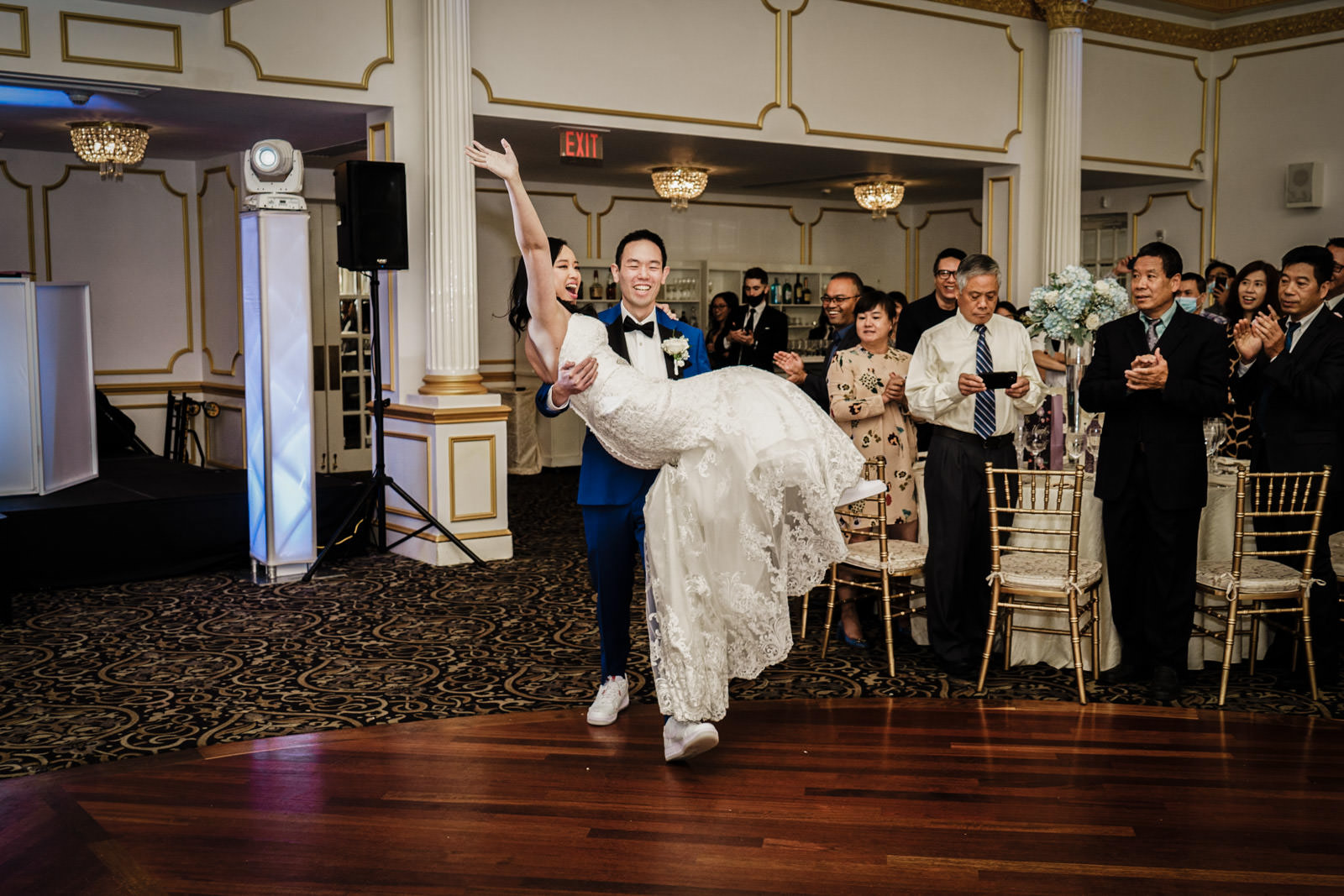 Groom carrying bride through reception entrance at Crystal Plaza, Livingston NJ