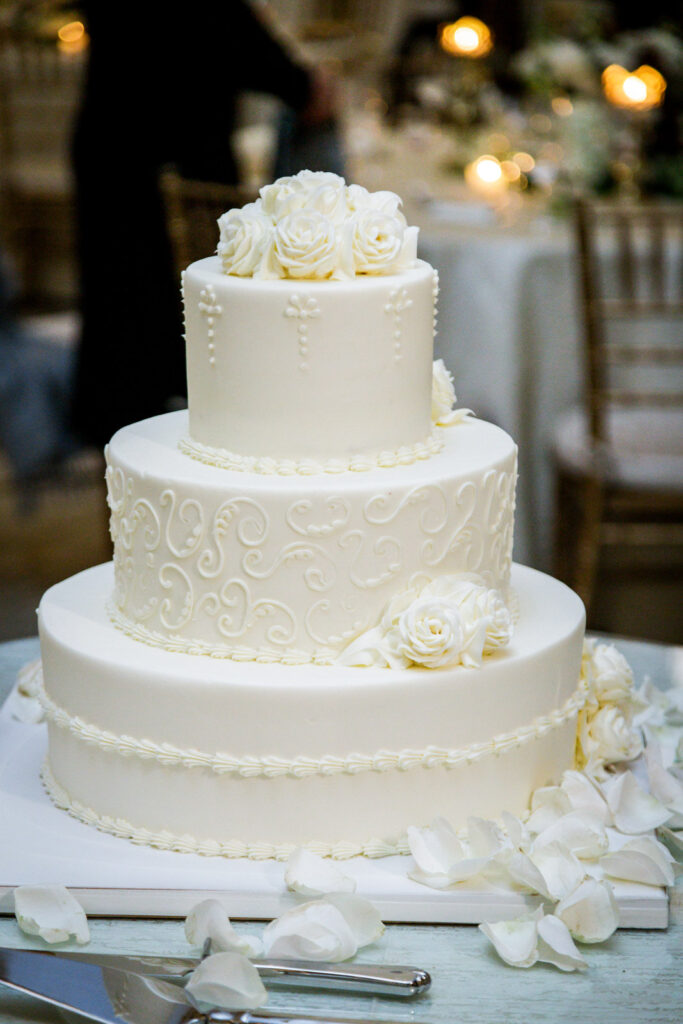 Three tier white wedding cake with rose details and scrollwork piping at Crystal Plaza New Jersey