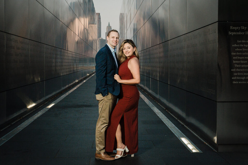 Couple smiling inside the Empty Sky Memorial corridor during engagement session in Jersey City
