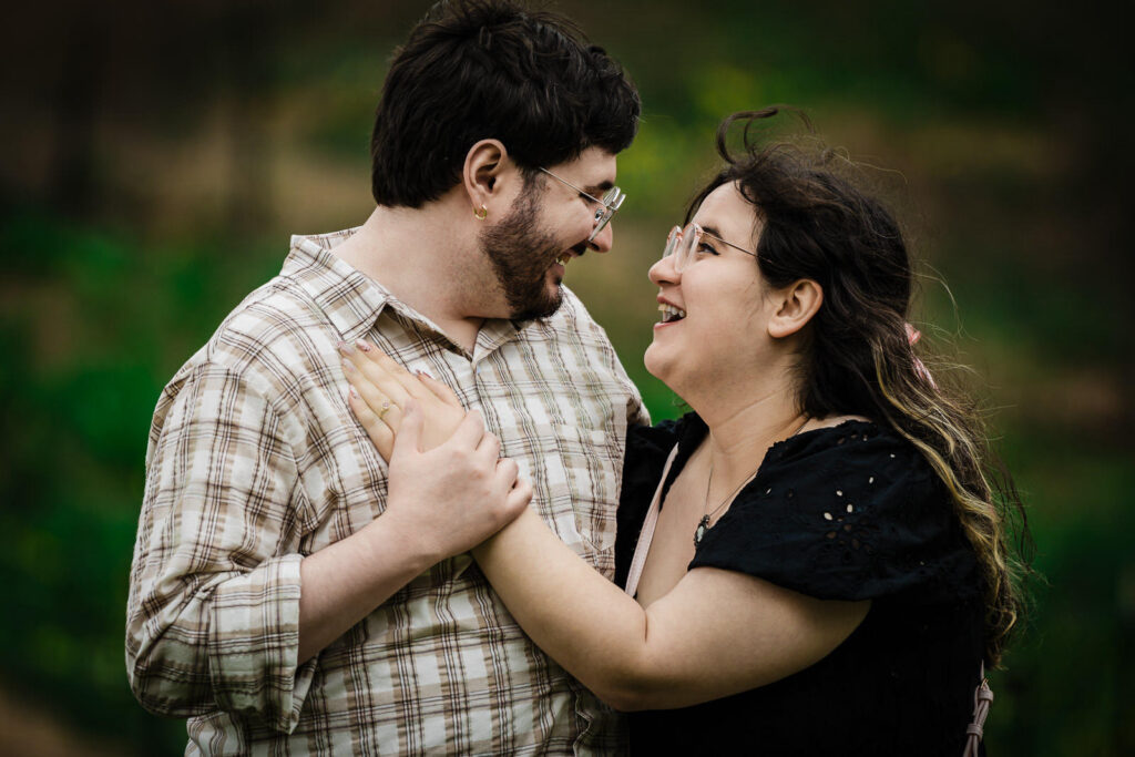 Close portrait of newly engaged couple laughing together outdoors at Reeves-Reed Arboretum New Jersey