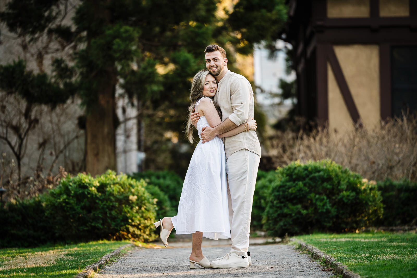 Couple embracing on garden path during engagement session at Van Vleck House Gardens NJ