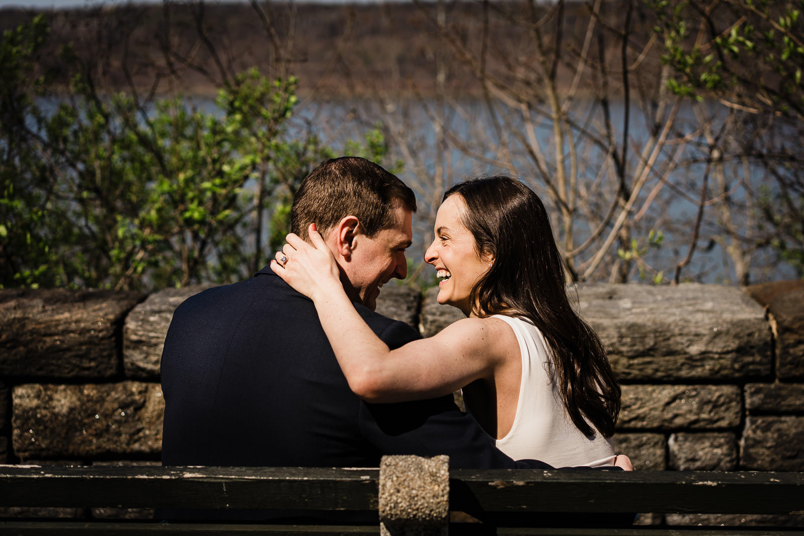 Couple on bench at Fort Tryon Park with Hudson River in the background
