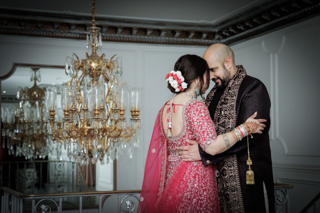 Indian wedding couple sharing quiet intimate moment near gold chandelier at Crystal Plaza NJ