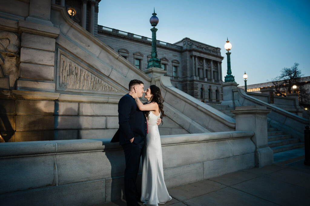 Couple nearly kissing on Library of Congress steps at blue hour in Washington DC