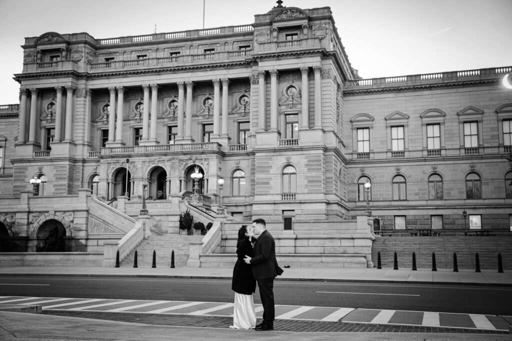 Black and white photo of couple kissing in the street in front of the Library of Congress Washington DC