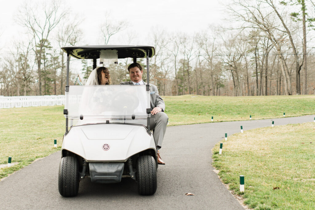 Bride and groom laughing together in golf cart at Pinelands Golf Club Hammonton NJ wedding day