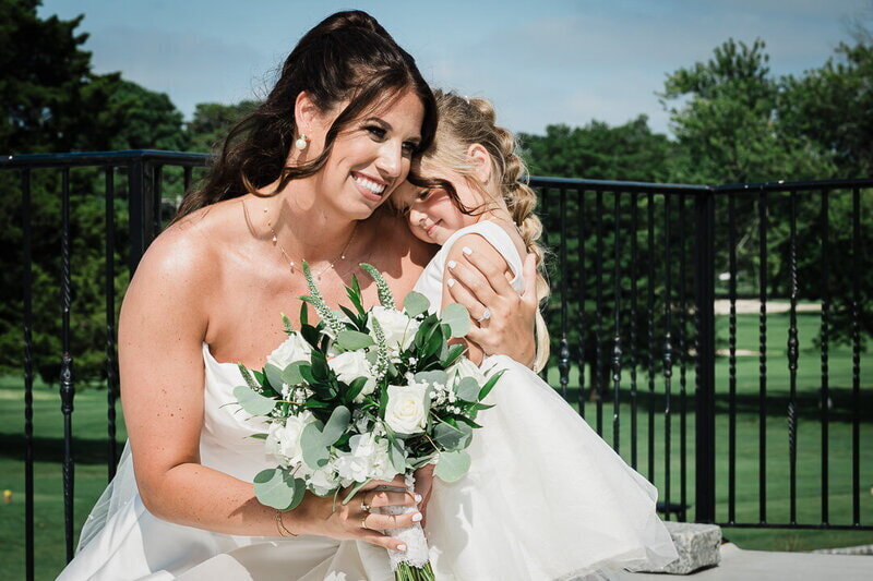 Bride sharing a tender moment with flower girl during an intimate New Jersey wedding ceremony