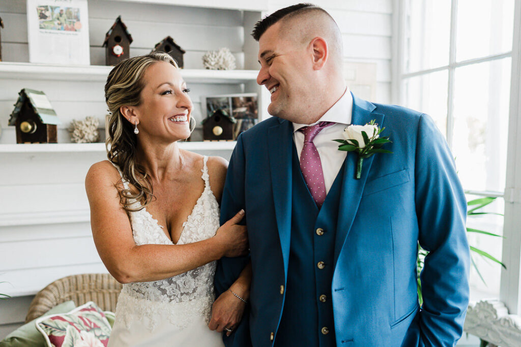 Bride and groom sharing a candid smiling moment indoors at a New Jersey wedding photographed by Alex Kaplan