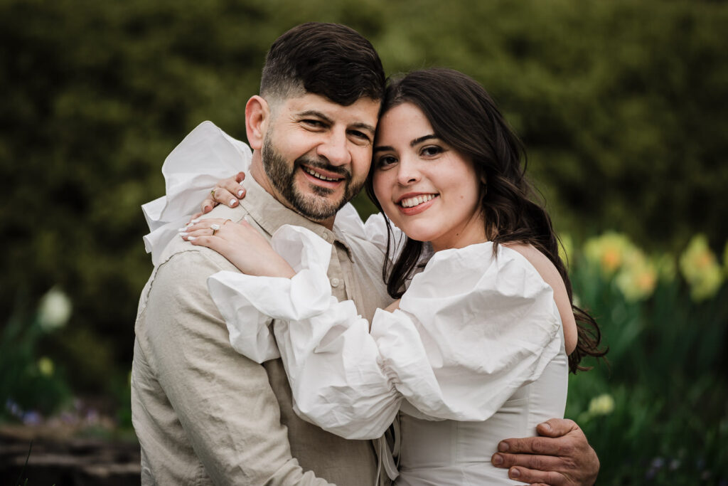 Luiz and Dryellen laughing cheek-to-cheek after their engagement at Deep Cut Gardens NJ