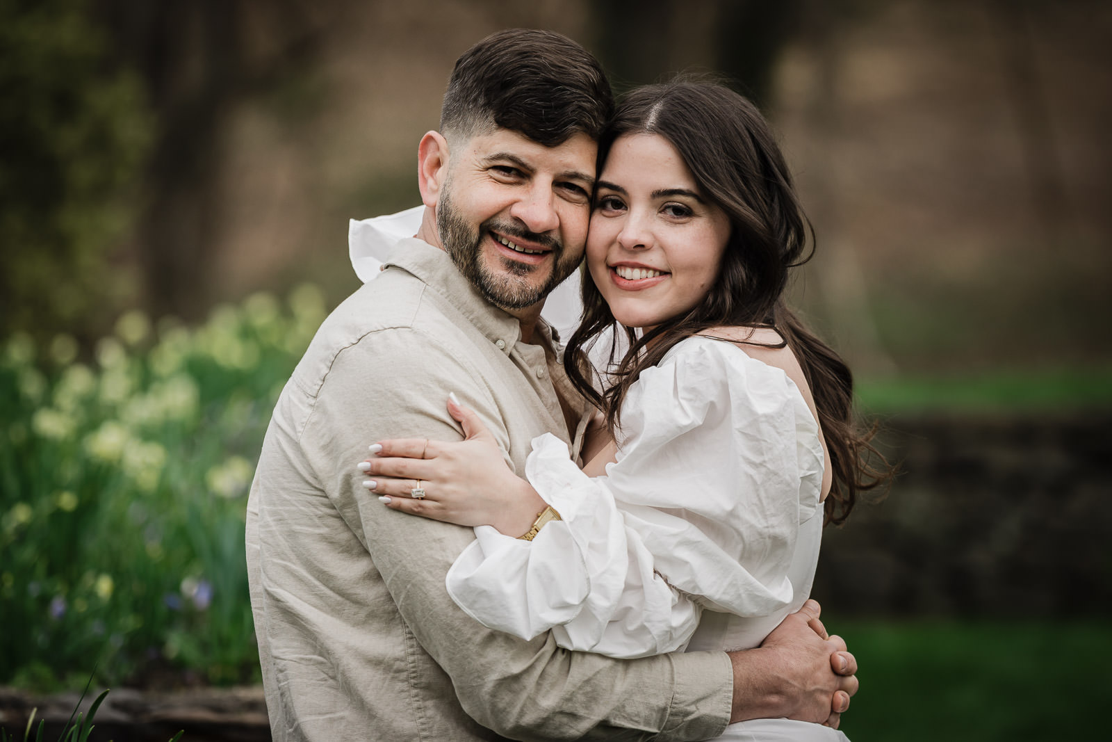 Engaged couple embracing each other at Deep Cut Gardens in spring