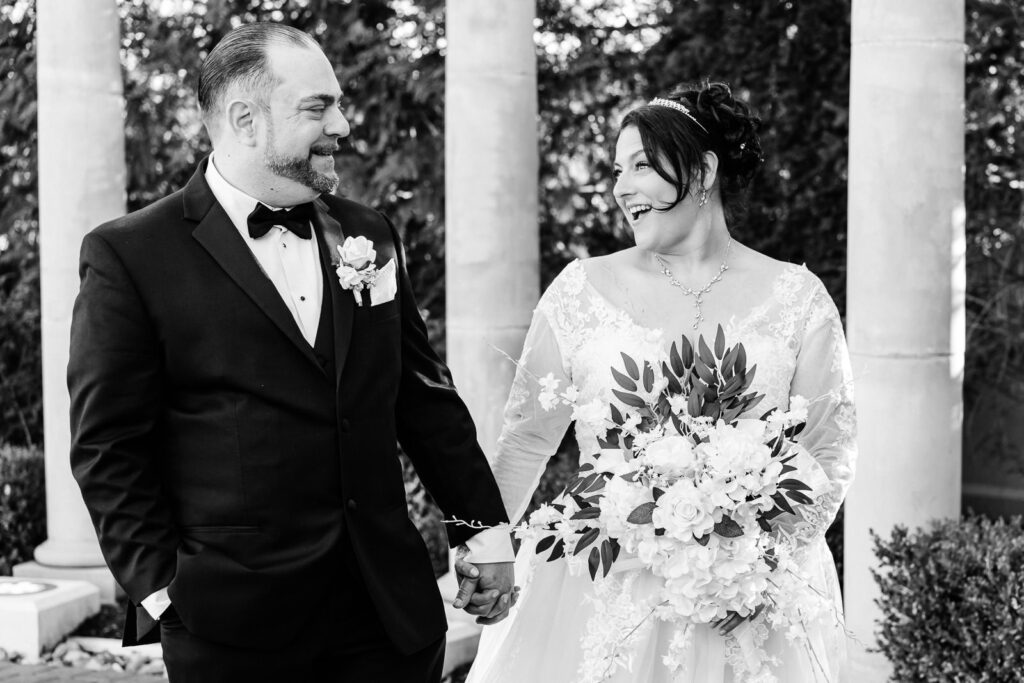 Black and white portrait of bride and groom laughing at Macaluso's wedding Hawthorne NJ