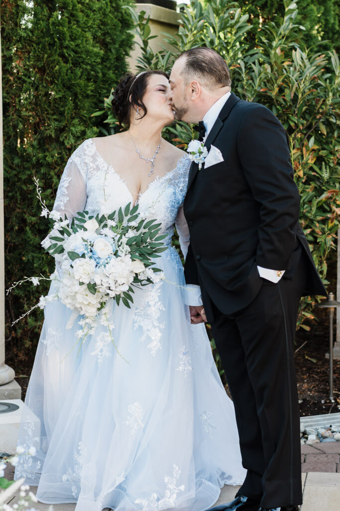 Bride and groom kissing in garden at Macaluso's wedding venue Hawthorne NJ