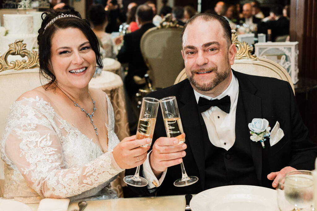 Bride and groom champagne toast at sweetheart table Macaluso's wedding Hawthorne NJ