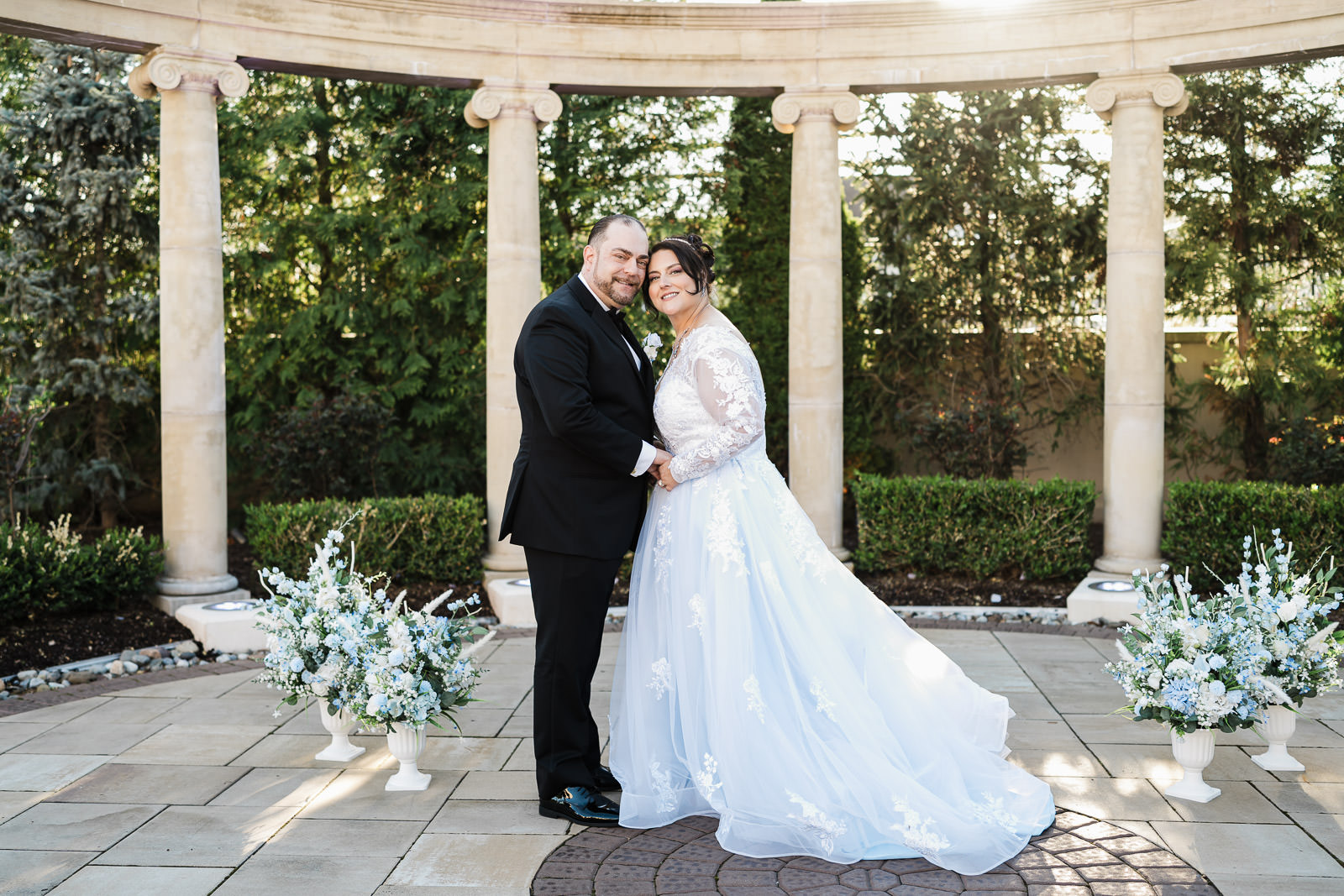 Bride and groom portrait under ionic columns at Macaluso's wedding Hawthorne NJ