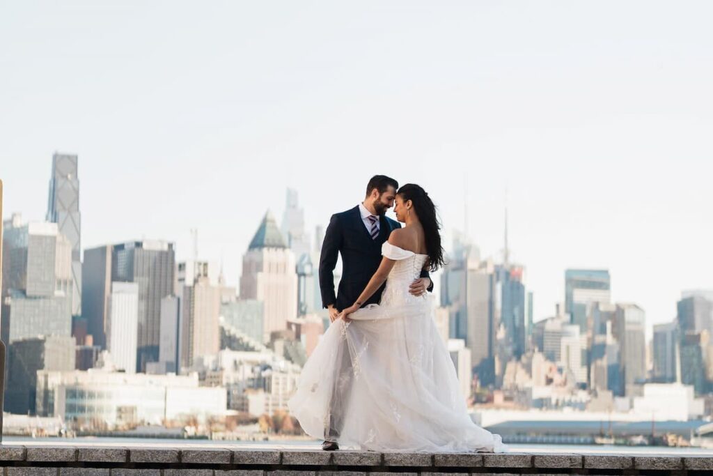 Romantic wedding portrait of couple on Hoboken waterfront with Manhattan NYC skyline at golden hour by Alex Kaplan Photography