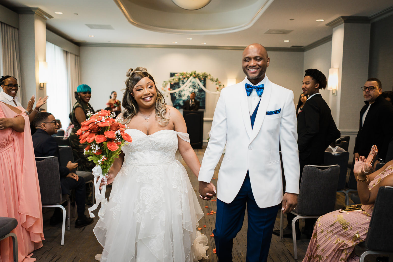 Joyful bride and groom walking hand in hand after ceremony at Sheraton Parsippany Hotel New Jersey wedding