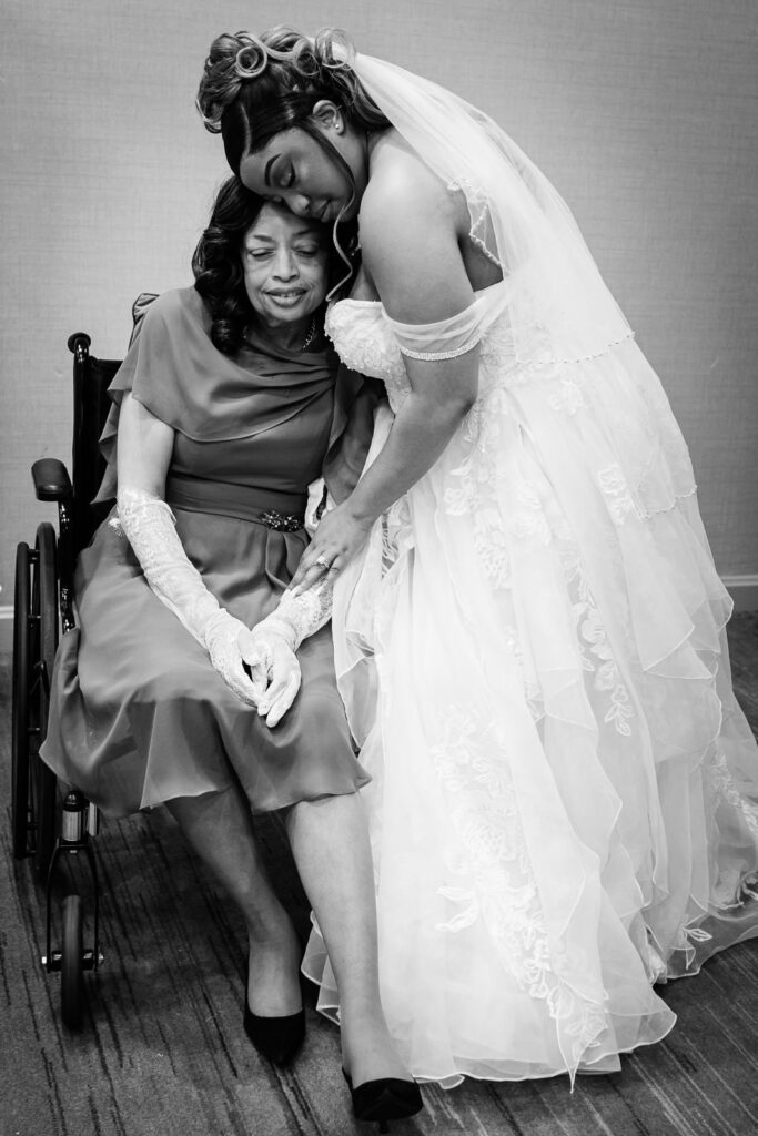 Emotional black and white portrait of bride leaning on mother at New Jersey hotel wedding