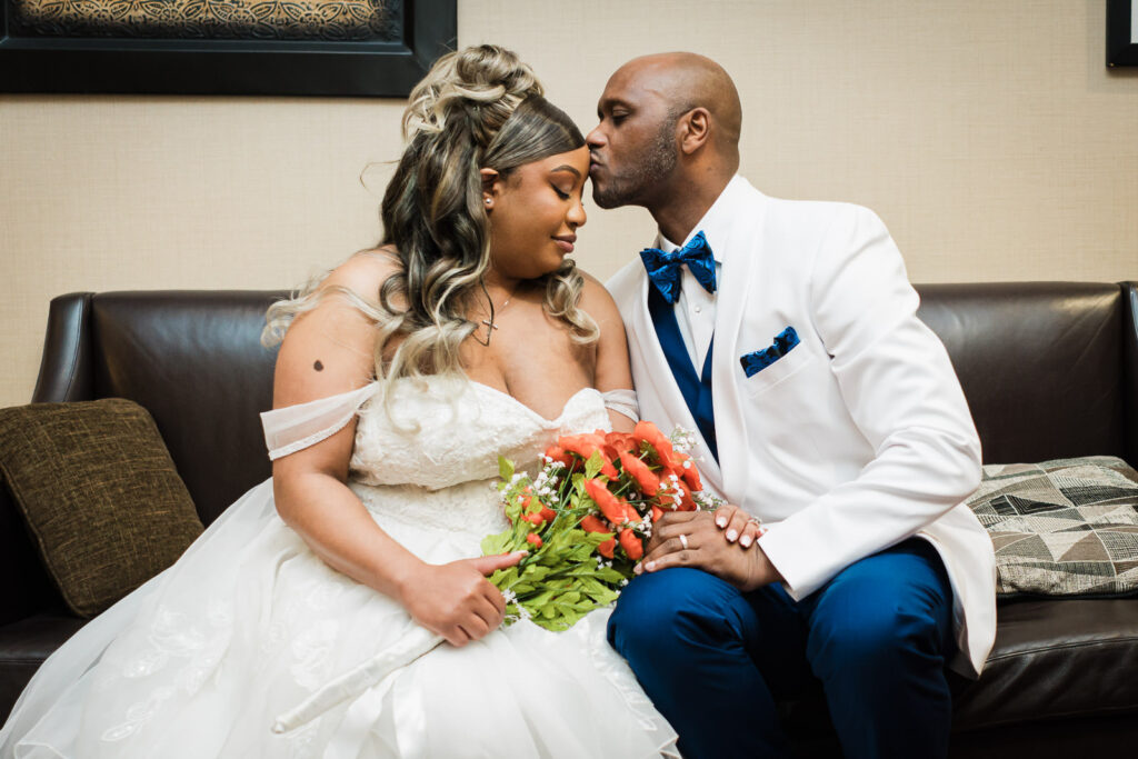 Groom gently kissing bride on forehead during intimate portrait session at Sheraton Parsippany Hotel NJ