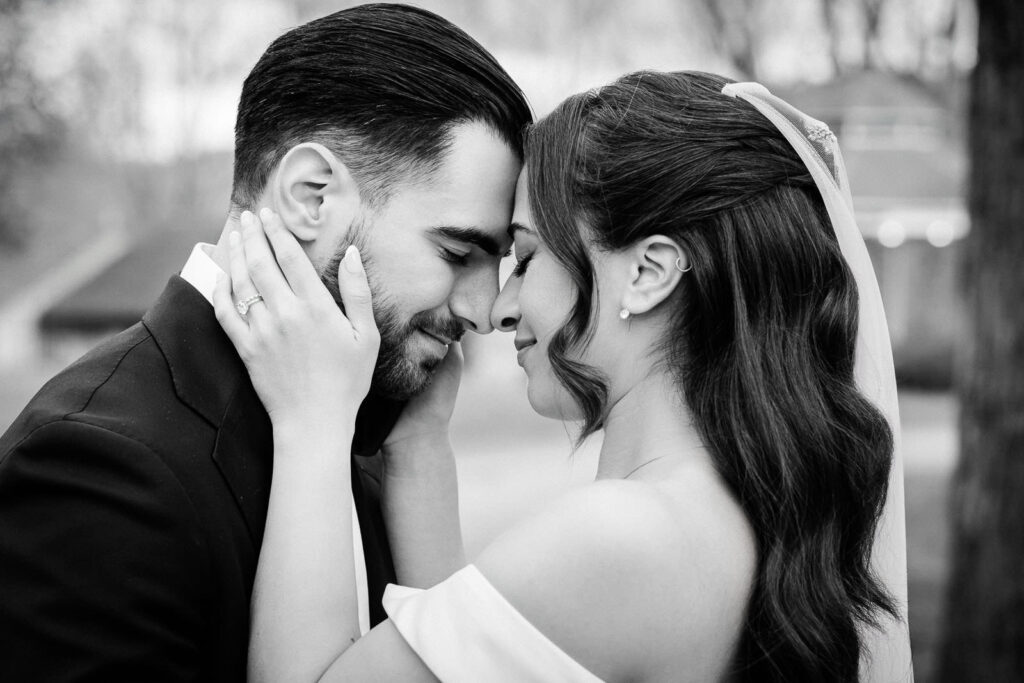 Black and white close portrait of Kiara and Otari face to face in a
tender moment during Waterloo Village wedding portraits in New Jersey