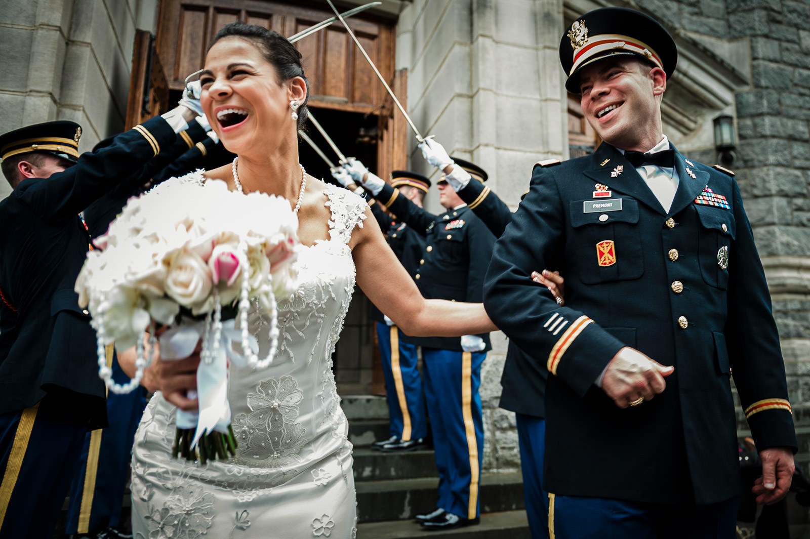 Bride laughing during a West Point military wedding saber arch exit photographed by Alex Kaplan Weddings.