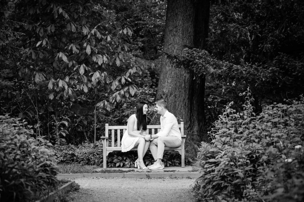 Black and white candid of a couple sharing a quiet moment on a garden bench at Van Vleck in Montclair